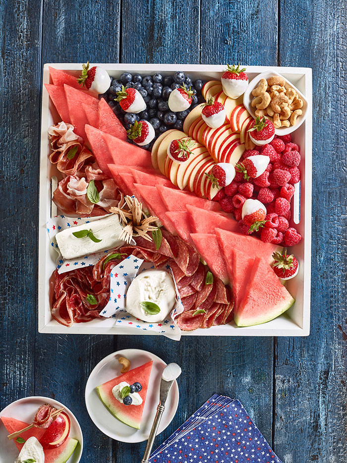 A patriotic charcuterie board featuring watermelon slices