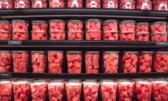 watermelon chunks in various sized plastic containers on 4 shelves, produce department