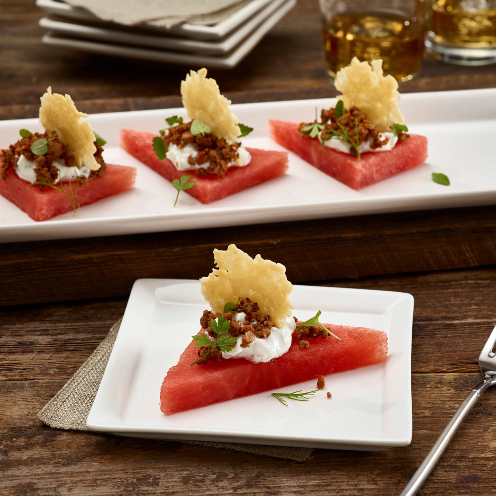 Watermelon Lamb Chorizo Bites on a rectangular serving plate with one served on appetizer plate.