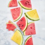 red and yellow triangular cuts on watermelon on marble background