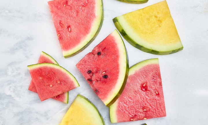 red and yellow triangular cuts on watermelon on marble background