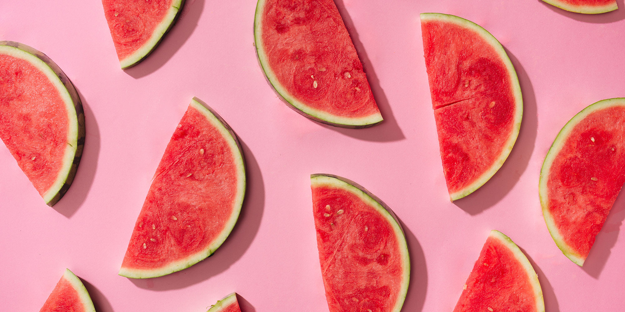 watermelon slices/halves set on pink background