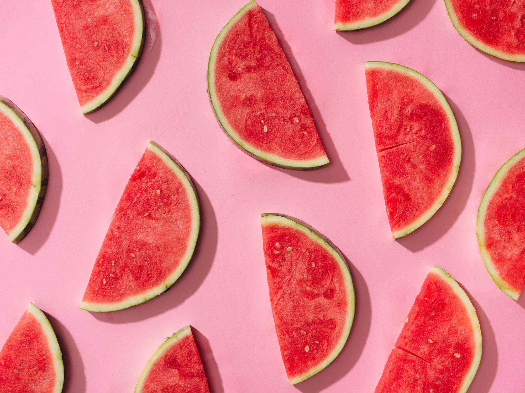 watermelon slices/halves set on pink background