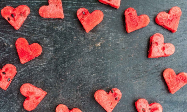 watermelon heart cutouts on black wooden table