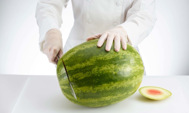 chef cutting ends of watermelon