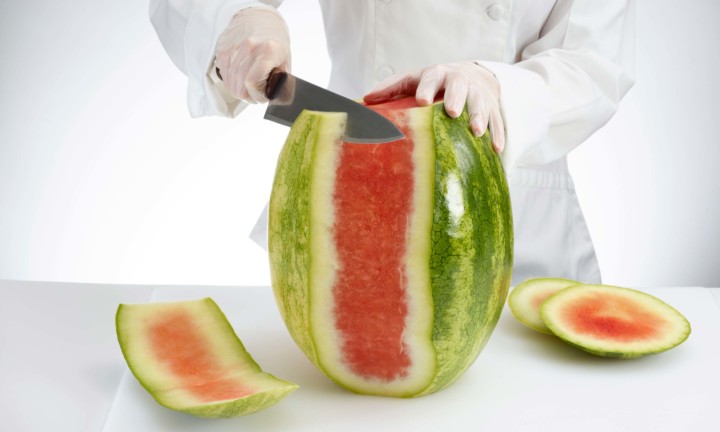 chef cutting rind off watermelon