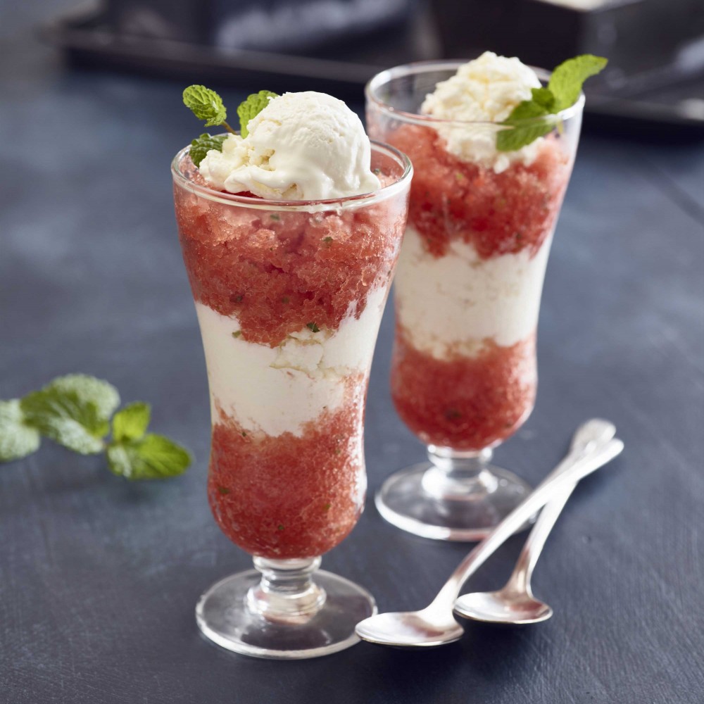 Lime Mint Watermelon Granita (x2) in small dessert/parfait style clear glasses with two spoons in foreground. Mint garnish. Ingredients in background