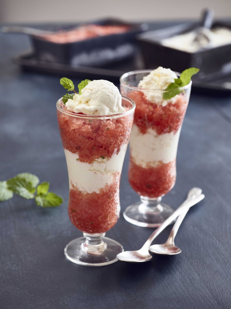 Lime Mint Watermelon Granita (x2) in small dessert/parfait style clear glasses with two spoons in foreground. Mint garnish. Ingredients in background