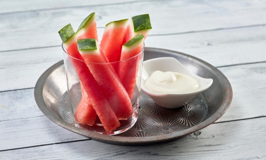 Watermelon Dippers in clear glass/cup, set in metal pan with small condiment dish with dip