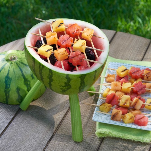 Watermelon Grill - carving with skewers of fruit on top of 