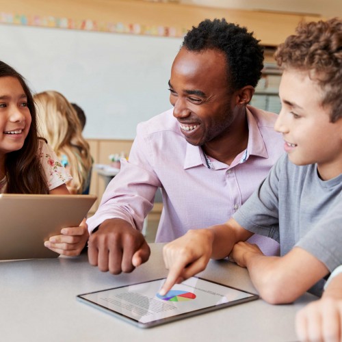 Educators - two student and one teacher holding and using tablets