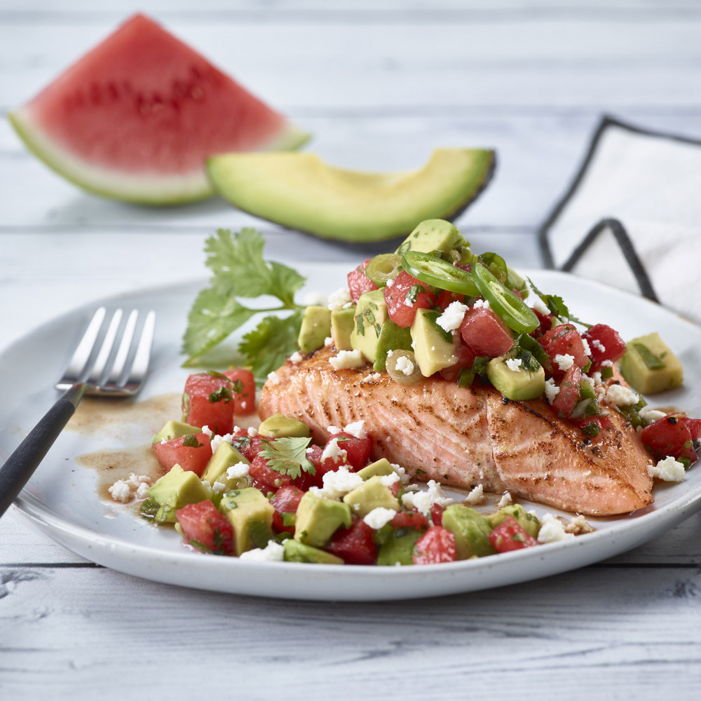 plated salmon topped with watermelon avocado salsa