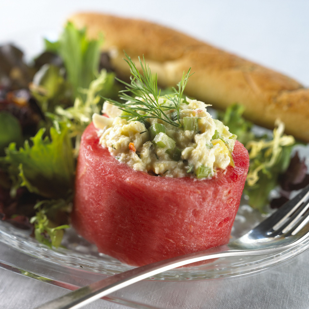 A filled watermelon cup with crab salad