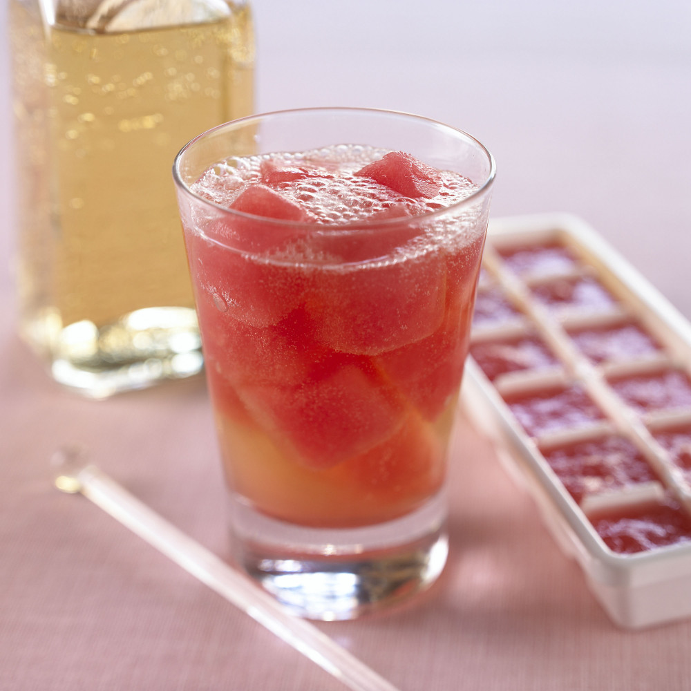 Watermelon ice cubes in a tray and in a beverage