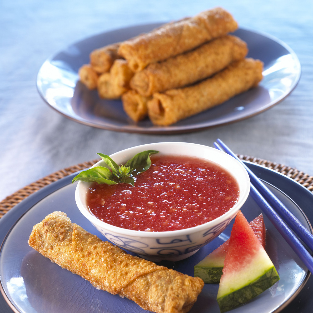 A dish of lobster spring rolls with watermelon sauce