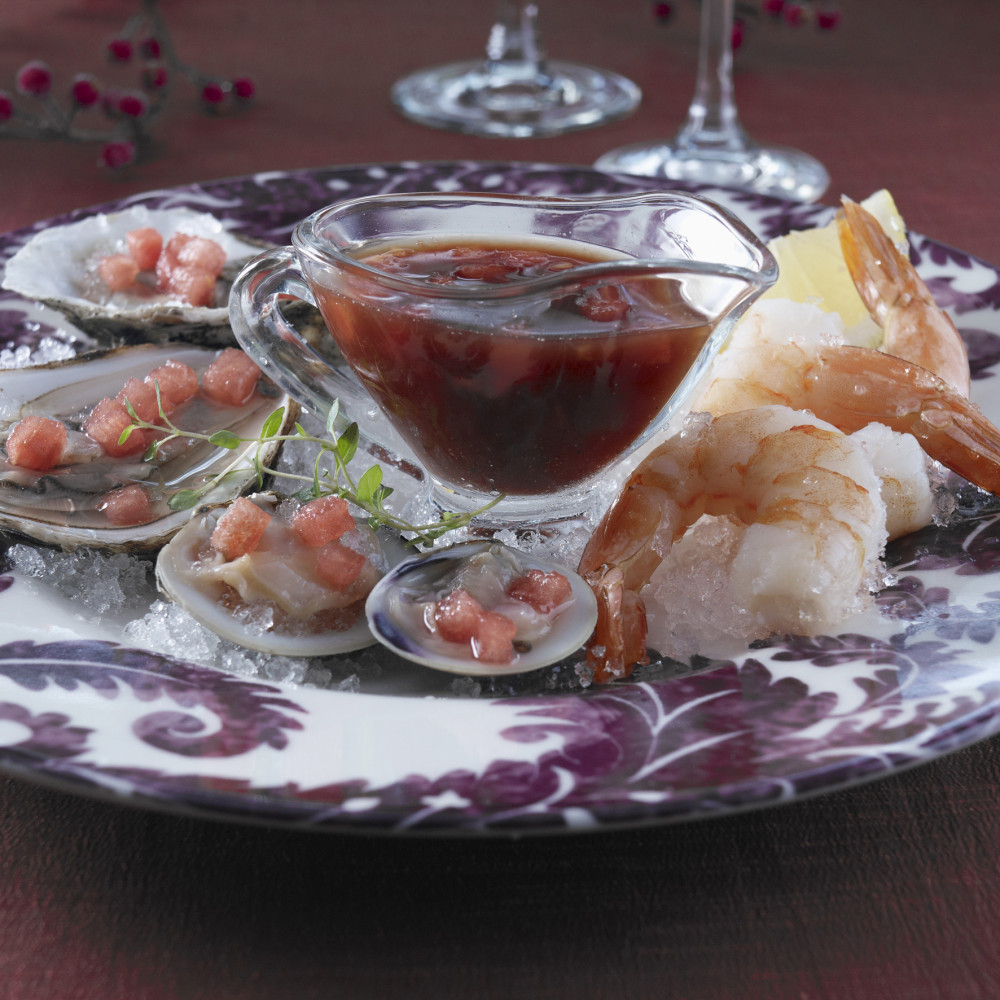 plated seafood (oysters & shrimp) with serving cup of mignonette sauce (lemon wedge)