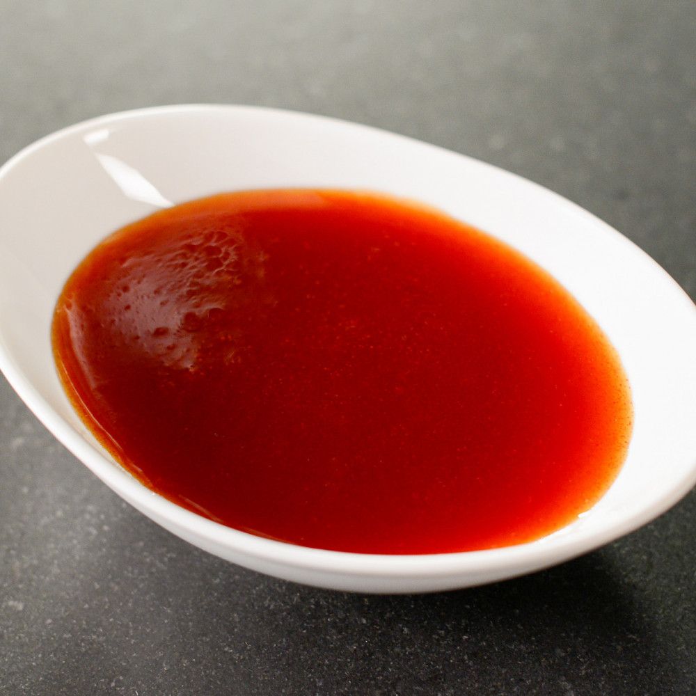 Watermelon Molasses served in white round bowl.