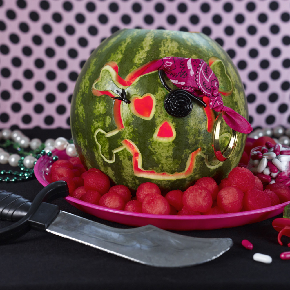 Pirate Girl Skull set on platter with watermelon balls around and treasure pieces and knife.