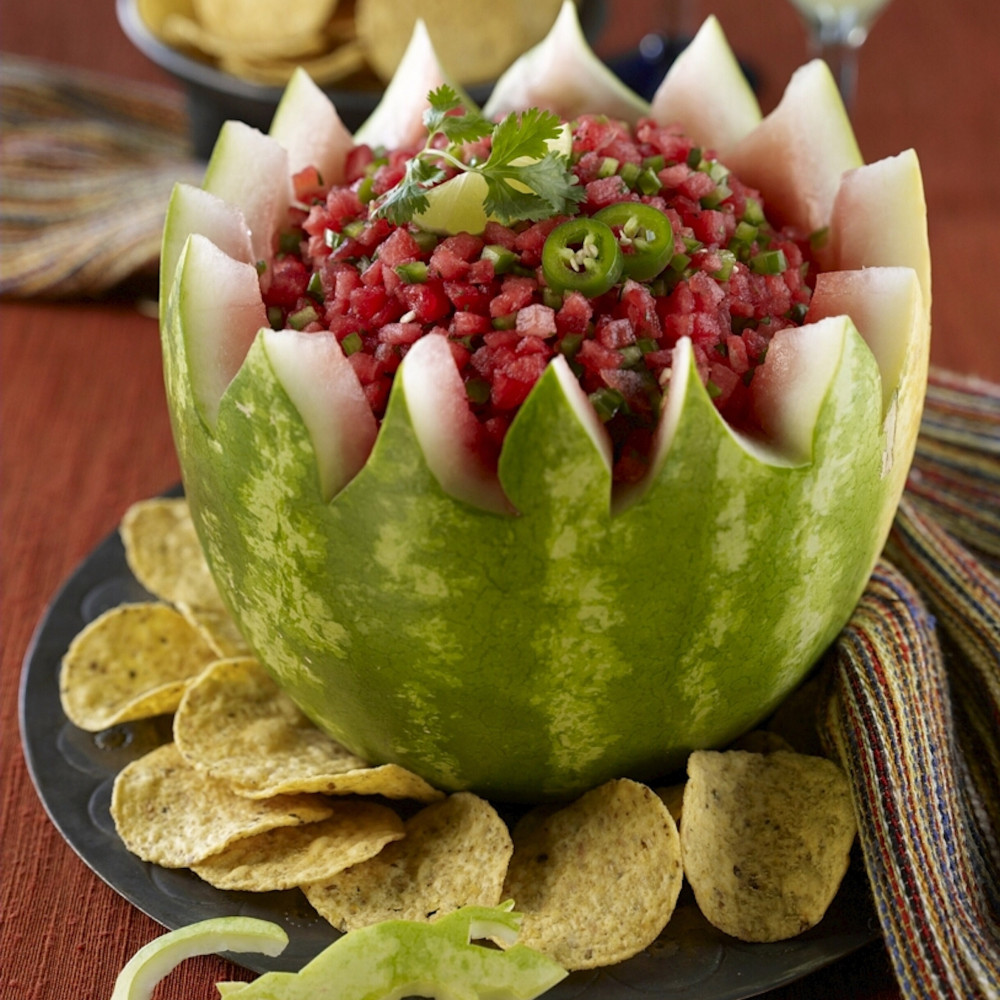 Salsa Bowl with chips on side and in background. Margarita in background. Toy lizard in foreground.