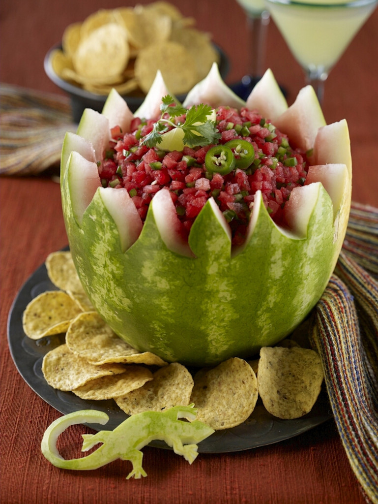 Salsa Bowl with chips on side and in background. Margarita in background. Toy lizard in foreground.