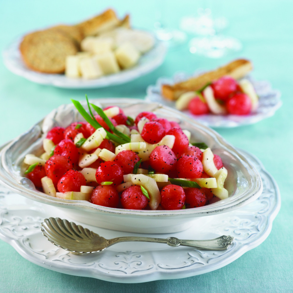 plated and bowled watermelon cucumber salad on aqua tablecloth