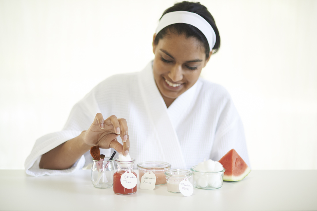 watermelon scrub with woman in robe preparing to apply
