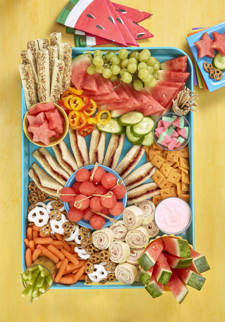 Kids grazing board overhead shot showing sandwiches, cracker, watermelon and other fruit