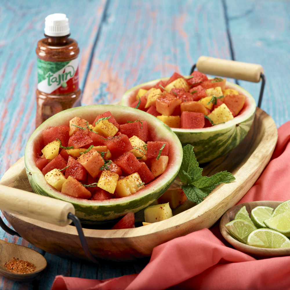 Tajin fruit salad served in hollowed out mini watermelons