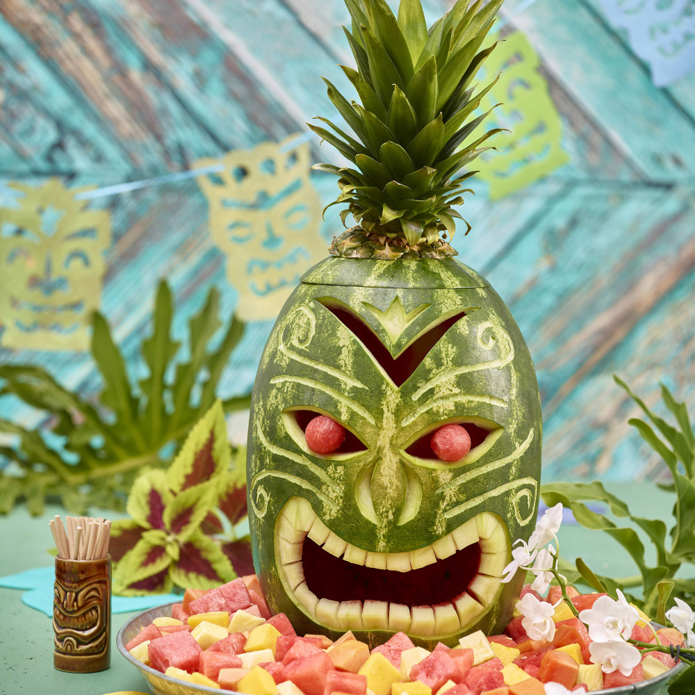 Watermelon tiki mask centerpiece with pineapple topper
