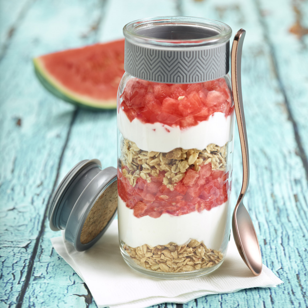 Breakfast parfait layered in a to-go jar with spoon