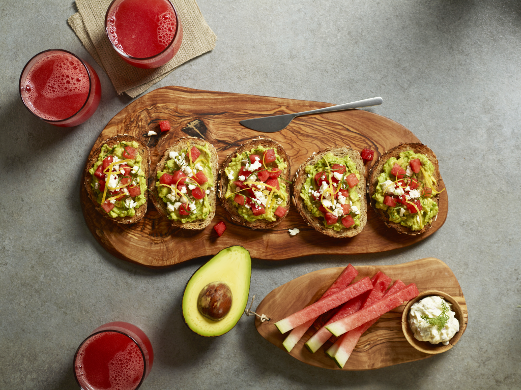 avocado toast pieces on board with juice on the side