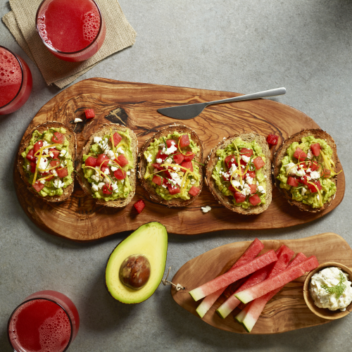 avocado toast pieces on board with juice on the side