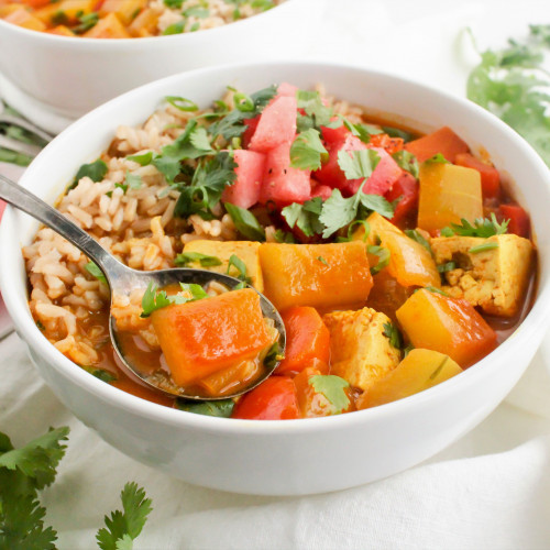 rind curry in bowl with garnish of parsley and watermelon chunks