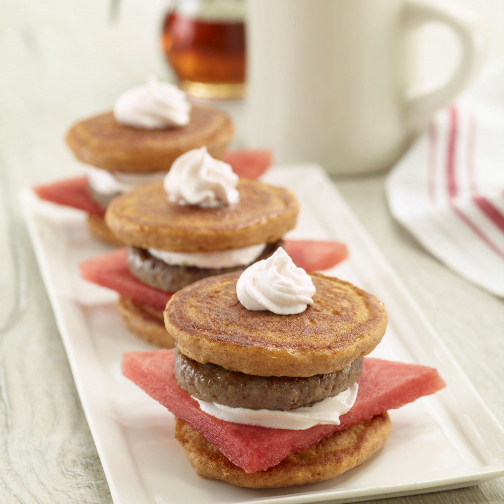 3 watermelon pancake sandwiches plated on white rectangular plate