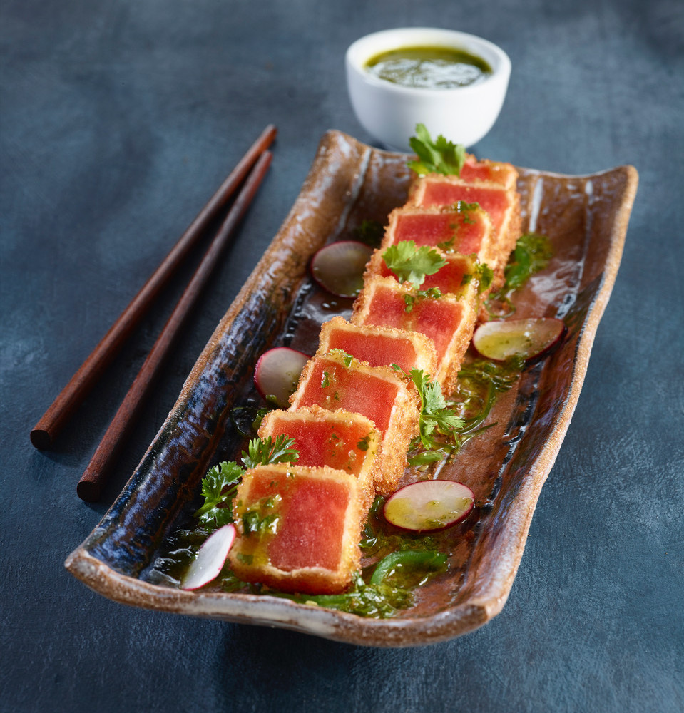 Fried Watermelon with salami salad plated on rectangular sushi plate with chopsticks and small sauce dish on side