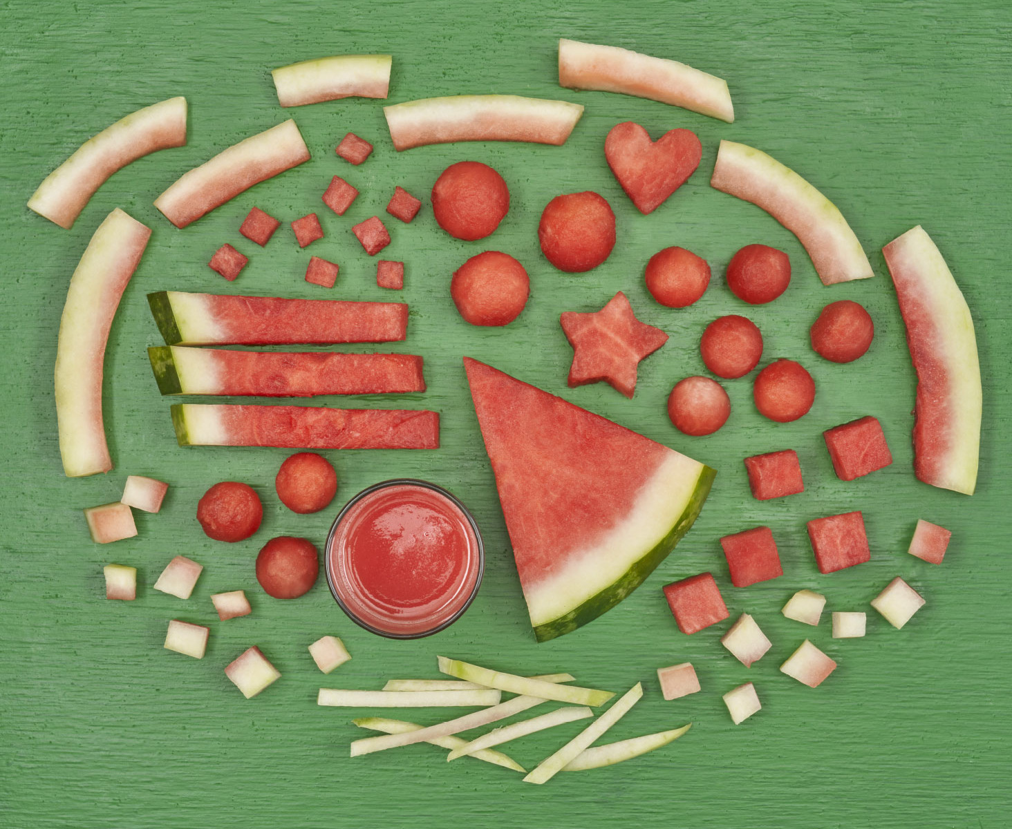 Watermelon cut butchery-style on a green board
