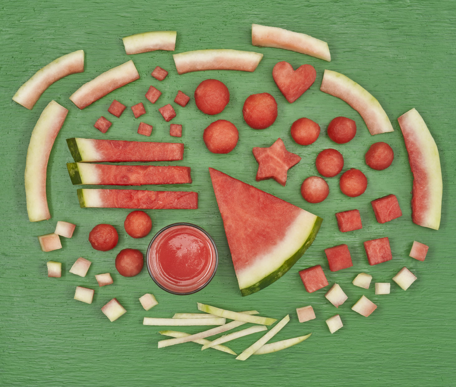 Watermelon cut butchery-style on a green board