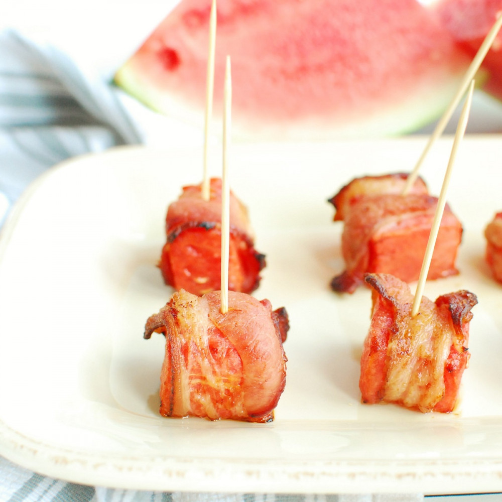 cubed watermelon wrapped in bacon with toothpick