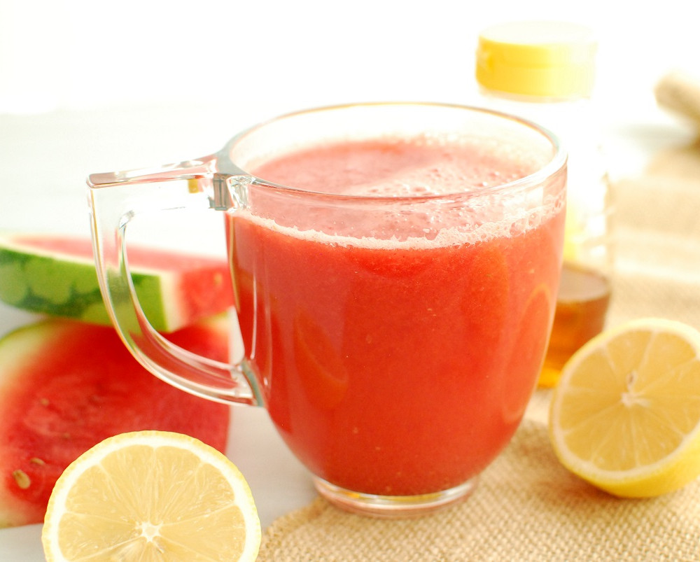 watermelon tea in clear mug with lemons