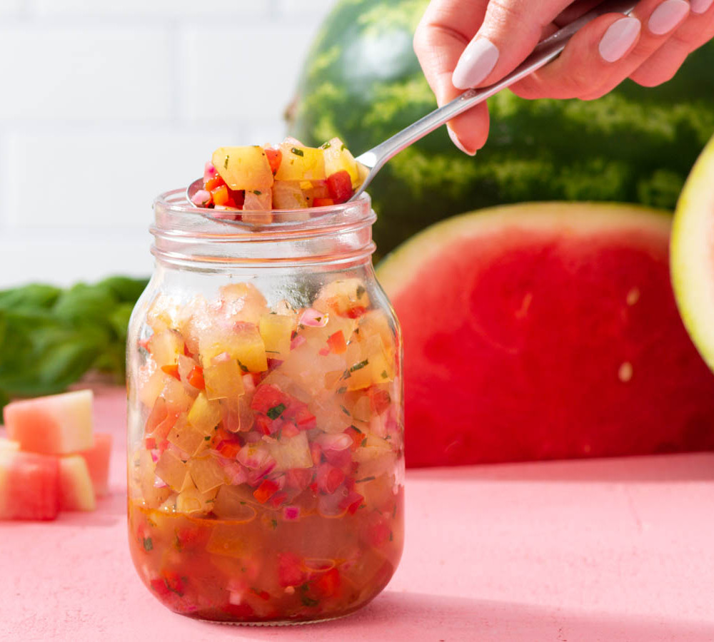 relish in a mason jar in front of watermelon