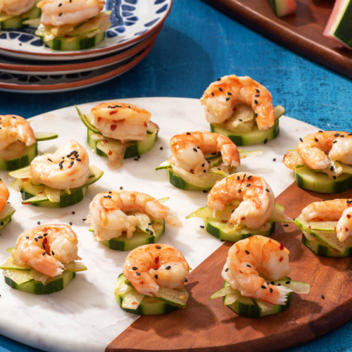 shrimp on cucumbers with pickled watermelon rind on a platter