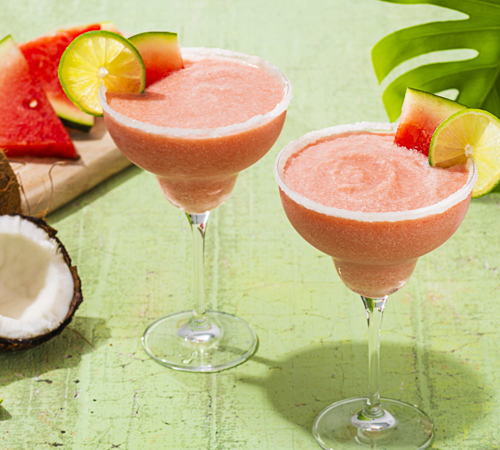 two watermelon coconut frozen margaritas with salted rims