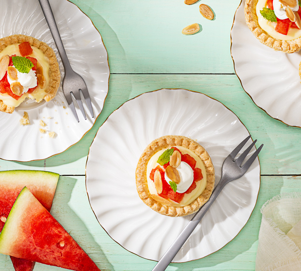 4 watermelon tarts on a plates with a fork