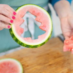 person holding sample of watermelon Christmas tree cutout pieces