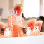 mule mugs with pitcher, people in background