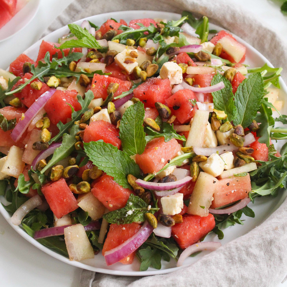 Watermelon Rind Salad with feta in a bowl with napkin and spoon