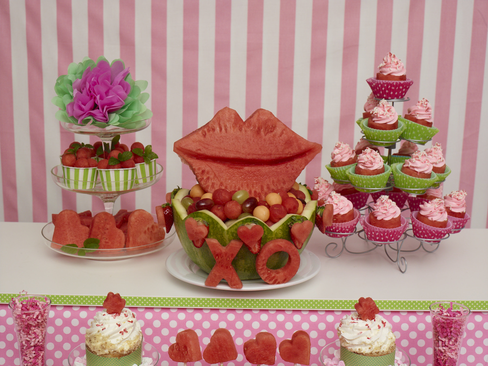 Valentine party spread with watermelon cupcakes, cuts and a lips and love carved watermelon basket