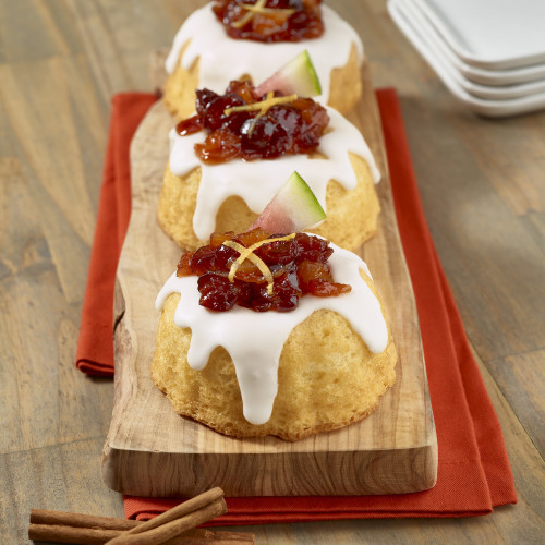 Watermelon and cranberry topping on mini bundt cakes with icing.