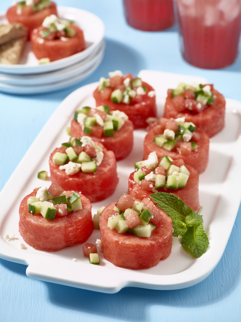 Watermelon cup appetizers with cucumber, mint and feta on serving plate.