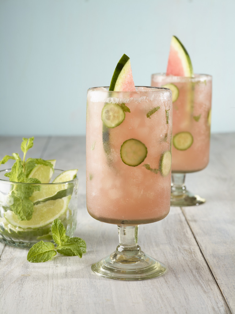 Two watermelon, cucumber and mint spritz beverages with watermelon spears.